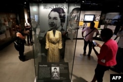 FILE - Civil Rights pioneer Rosa Parks' dress is on display in the concourse galleries at the Smithsonian's National Museum of African American History and Culture on the National Mall Sept. 14, 2016 in Washington, D.C.