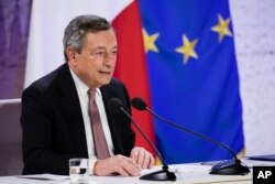 Italy's Prime Minister Mario Draghi reads statement during a press conference at the La Nuvola conference center for the G20 summit in Rome, Oct. 31, 2021.