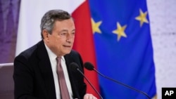 FILE - Italy's Prime Minister Mario Draghi reads statement during a press conference at the La Nuvola conference center for the G-20 summit in Rome, Oct. 31, 2021.