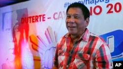 FILE - Rodrigo Duterte smiles during a news conference shortly after voting in a polling precinct at Daniel R. Aguinaldo National High School, Matina district, his hometown in Davao city in southern Philippines, May 9, 2016.