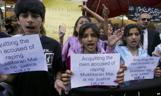 FILE - Members of a Pakistani civil society hold a protest against a Supreme Court decision to free five men accused in the notorious gang-rape of a woman under orders from a village council in 2002, angering the victim and human rights groups.