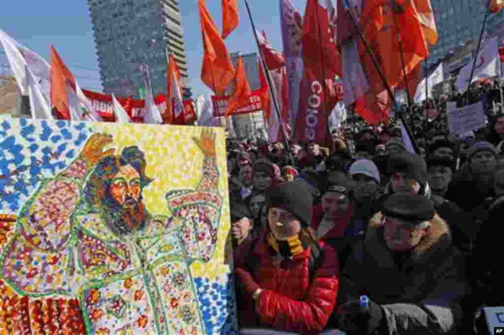 Opposition protesters with a placard depicting Czar Ivan The Terrible gathered during a rally in Moscow, Russia, Saturday, March 10, 2012. The demonstrators gathered in central Moscow to protest electoral fraud. Saturday's rally is widely seen as evidence