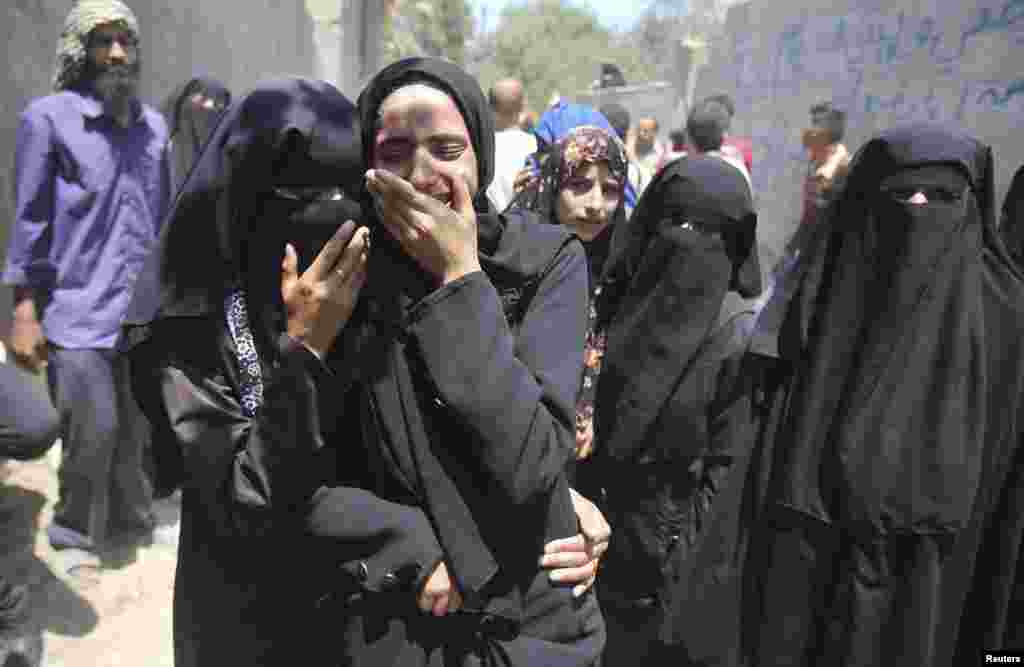 Relatives of four-year-old Palestinian girl Sarah Sheik al-Eid, who medics said was killed along with her father and uncle in an Israeli air strike, mourn during their funeral in Rafah, southern Gaza Strip, July 15, 2014.