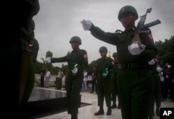 Soldiers march at the Martyrs' Mausoleum during a ceremony to mark the 70th anniversary of the 1947 assassination of independence hero Gen. Aung San, the late father of State Counselor Aung San Suu Kyi, in Yangon, Myanmar, July 19, 2017.