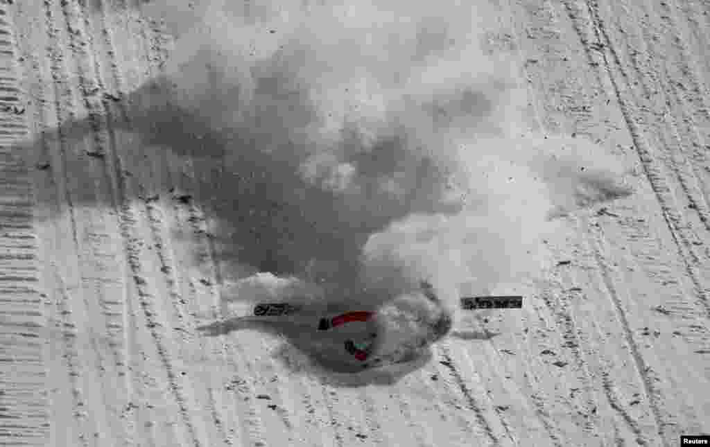 Simon Ammann from Switzerland crashes after landing during the first round of the 63rd four-hills ski jumping tournament in Oberstdorf, southern Germany.