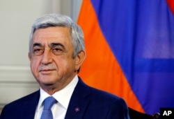 FILE - Serzh Sargsyan poses at the opening of talks with Azerbaijan in Geneva, Switzerland, Oct. 16, 2017.