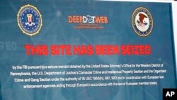 FILE: A poster showing the seized website screen of Deep.Dot.Web is displayed during a news conference about the shutting down of the web site and the arrest of the people running it. Pittsburgh, May 8, 2019.