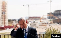 Israeli Prime Minister Benjamin Netanyahu delivers a statement in front of a new construction, in the Jewish settlement known to Israelis as Har Homa and to Palestinians as Jabal Abu Ghneim, March 16, 2015