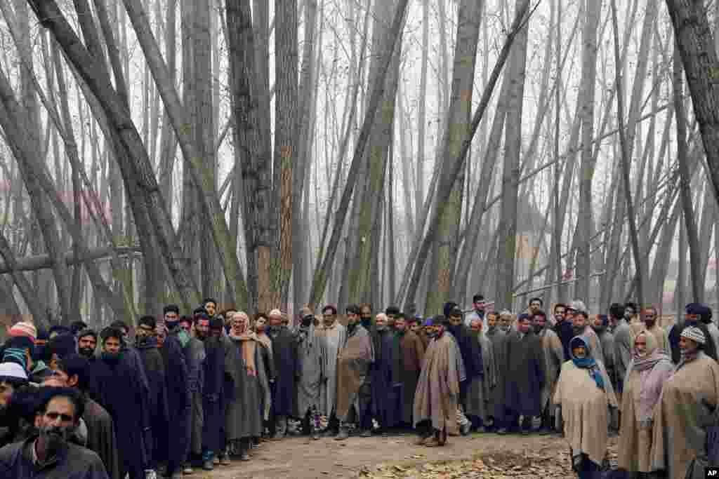 Kashmiris stand in line to cast their votes outside a polling station during the first phase of voting in the Jammu and Kashmir state assembly elections in Srinagar, Indian controlled Kashmir.