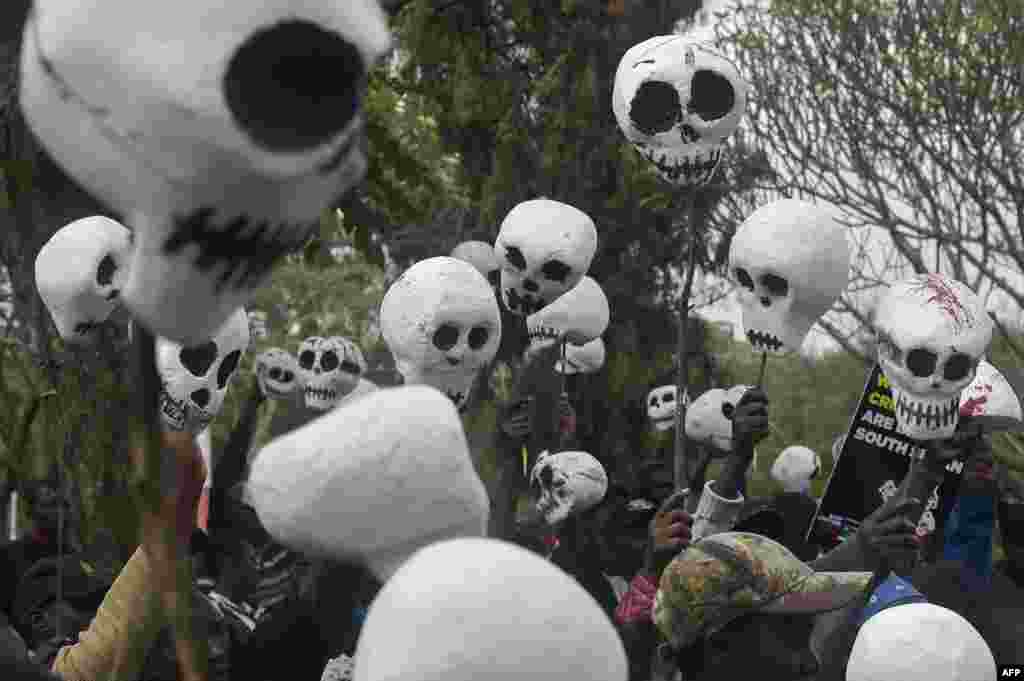 South Sudanese citizens living in Kenya hold up mock skulls as they demonstrate in the capital Nairobi, to request the government to freeze assets of South Sudan leaders involved in the ongoing conflict in their country.