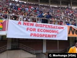 Supporters of President Emmerson Mnangagwa display a banner in Harare, April 18, 2018, showing what the new government is promising Zimbabweans.