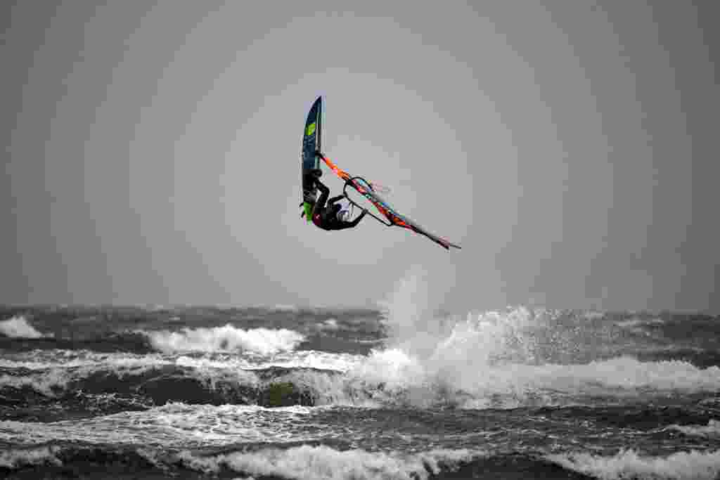 A windsurfer performs a trick at Barassie Beach in Troon, on the west coast of Scotland on Boxing Day, Dec. 26, 2020, as Storm Bella brings rain and high winds to the UK.