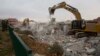 Bulldozers demolish houses in the West Bank settlement of Ofra, March 1, 2017. 