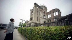 FILE - In this July 3, 2015, photo, Kimie Mihara, a survivor of the 1945 atomic bombing, looks at the Atomic Bomb Dome, as it is known today in Hiroshima, Hiroshima Prefecture, southern Japan.