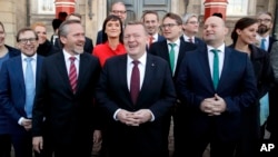 Danish Prime Minister Lars Loekke Rasmussen, center, presents his new government with 22 ministers in front of the Amalienborg Palace in Copenhagen, Nov. 28, 2016. At his left is Foreign Minister Anders Samuelsen.