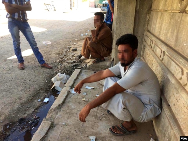 The IS resurgence in Tenek was unsuccessful at thwarting Iraqi forces movements in Mosul, but residents say they have no doubt more militants are hidden in their midst. Faces in this picture, taken in Mosul, Iraq, are blurred for security reasons, June 30, 2017. (H. Murdock/VOA)