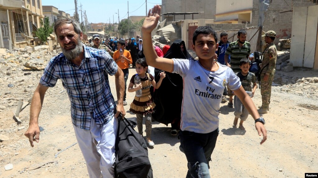 ປະຊາຊົນ ອີຣັກ ທີ່ໜີອອກຈາກບ້ານເຮືອນຂອງພວກເຂົາເຈົ້າ ໃນລະຫວ່າງ ການຕໍ່ສູ້ກັນຂອງກອງກຳລັງ ອີຣັກ ແລະ ພວກຫົວຮຸນແຮງລັດອິສລາມ, ໃນໝູ່ບ້ານ al-Zanjili ທາງພາກເໜືອຂອງເມືອງເກົ່າ ໂມຊູລ, ອີຣັກ. 30 ພຶດສະພາ, 2017.