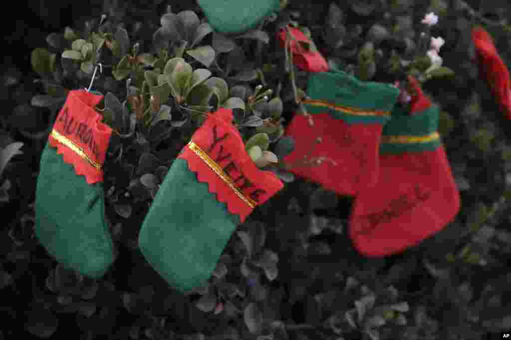 Christmas stockings with the names of Wednesday's shooting victims written on them adorn a makeshift memorial, Dec. 6, 2015, in San Bernardino, Calif.