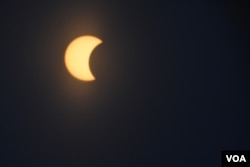The moon is seen as it passes in front of the sun during a partial solar eclipse in Washington, D.C., Monday, Aug. 21, 2017. (Diaa Bekheet/VOA)