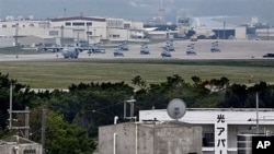 A military plane and helicopters are seen at Marine Corps Air Station Futenma in Ginowan, Okinawa, Japan (2009 File)