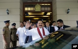 Sri Lankan Prime Minister Mahinda Rajapaksa waves after assuming duties as finance minister in Colombo, Sri Lanka, Oct. 31, 2018.