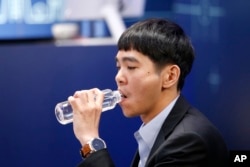 South Korean professional Go player Lee Sedol drinks a bottle of water after putting the first stone against Google's artificial intelligence program, AlphaGo, during the third match of the Google DeepMind Challenge Match in Seoul, South Korea, March 12,