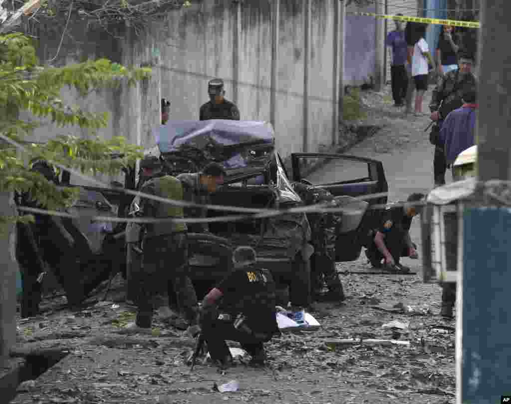 Police investigators examine the scene of an explosion in Zamboanga city in the southern Philippines, Sept. 16, 2013.