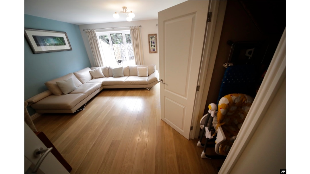 A cupboard under the stairs, which was replaced by one filmed in a studio, is shown next to the living room in the house for sale that starred onscreen as Harry Potter's childhood home in the town of Bracknell, England, west of London, Sept. 20, 2016.