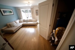 A cupboard under the stairs, which was replaced by one filmed in a studio, is shown next to the living room in the house for sale that starred onscreen as Harry Potter's childhood home in the town of Bracknell, England, west of London, Sept. 20, 2016.