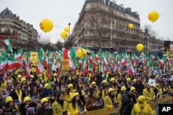 Iranian opposition protesters take the streets in Paris to protest against executions in Iran, as Iranian President Hassan Rouhani is in France for a two-day official visit, Jan. 28, 2016.