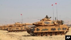 Turkey's Armed Forces officers in tanks take part in a military drill near the town of Silopi, Turkey, close to the Habur border gate between Turkey and the autonomous Kurdish region in Iraq, Sept. 18, 2017.
