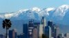 File - In this Jan. 12, 2016 file photo, the snow-capped San Gabriel Mountains stand as a backdrop to the downtown Los Angeles skyline. An initiative that seeks to split California into three states is projected to qualify for the state's November 2018 ballot.