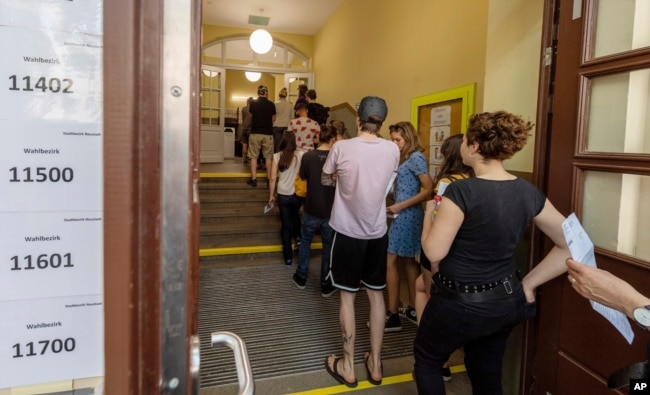 Voters line up at a polling station for European Parliament elections in Dresden, Germany, May 26, 2019.