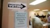 Sign points way to voting booths during presidential primary election at Sharon Presbyterian Church, Charlotte, North Carolina, March 15, 2016.
