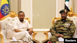 FILE: Ethiopian Prime Minister Abiy Ahmed meets Sudan's Head Of Transitional Military Council, Lieutenant General Abdel Fattah Al-Burhan Abdelrahman at the airport in Khartoum, Sudan 6.7.2019