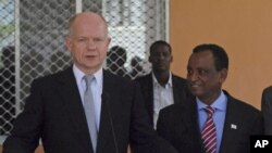 United Kingdom Foreign Secretary William Hague, left, speaks during a press conference at Mogadishu's presidential palace Somalia Thursday, Feb. 2, 2012. 