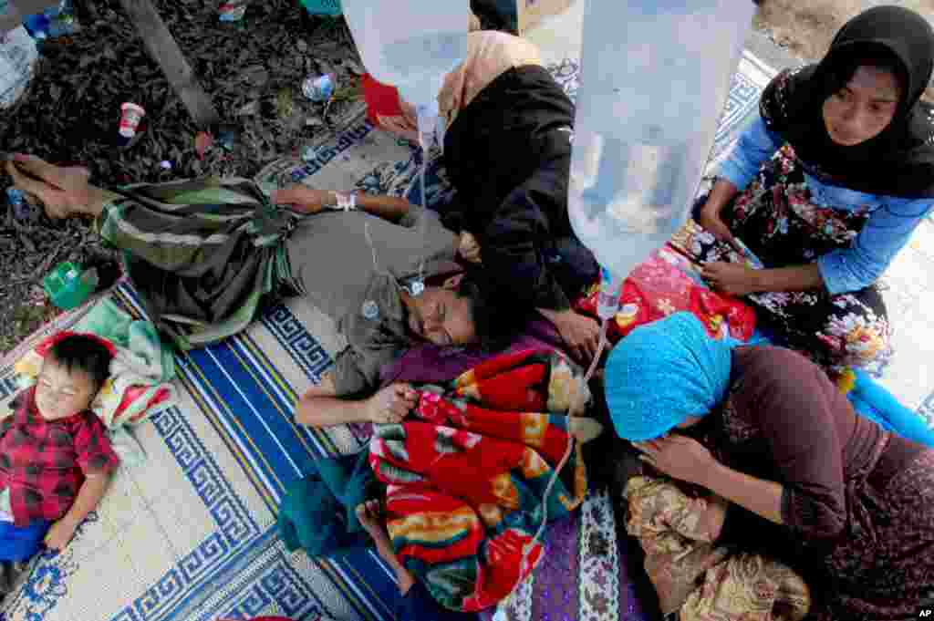 Residents injured in an earthquake are treated in the hallway of a crowded hospital in Bener Meriah, Aceh province, Indonesia. Soldiers, police and volunteers fanned out across an earthquake-damaged region of western Indonesia, scouring the debris of fallen homes and landslides for possible victims of a temblor that killed dozens of people and injured hundreds.