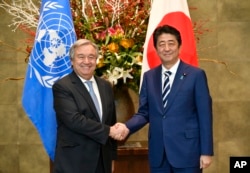 U.N. Secretary-General Antonio Guterres, left, and Japanese Prime Minister Shinzo Abe pose for a photo before their meeting at Abe's official residence in Tokyo, Dec. 14, 2017.