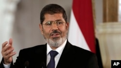 FILE - Egyptian President Mohammed Morsi speaks to reporters at the Presidential palace in Cairo, July 13, 2012.
