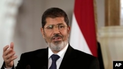 Egyptian President Mohammed Morsi speaks to reporters at the Presidential palace in Cairo in this July 13, 2012 file photo.