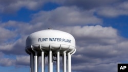 FILE - The Flint Water Plant water tower is seen in Flint, Michigan, March 21, 2016. Researchers from Virginia Tech say the lead levels in the city's drinking water is decreasing. 