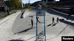 FILE - People play basketball at Superkilen park in Copenhagen, Denmark.