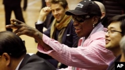 Former NBA basketball star Dennis Rodman and an interpreter look on during a basketball practice session in Pyongyang, North Korea on Friday, Dec. 20, 2013.