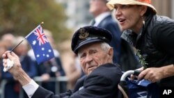 FILE - A veteran is pushed in a wheelchair during the ANZAC Day parade, in Sydney, Friday, April 25, 2014, commemorating the anniversary of the first major military action fought by Australian and New Zealand Army Corps (ANZAC) during the First World War.