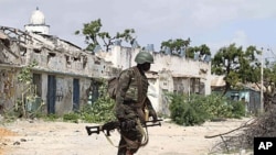 A Ugandan African Union peacekeeper patrols an empty street in the Wardigley district of southern Mogadishu, August 7, 2011