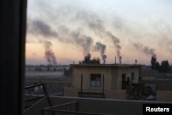 Smoke rises from clashes during a battle with Islamic State militants in southeast of Mosul, Iraq, Nov. 3, 2016