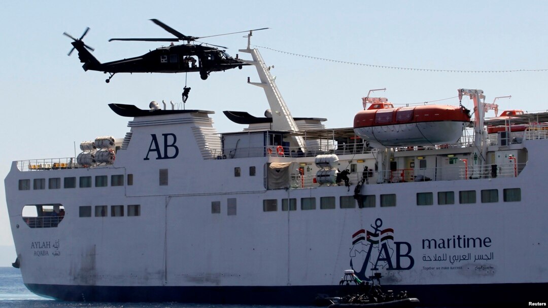 Members of the special forces abseil from a UH-60A Black Hawk helicopter as others use a rope ladder to board a ship during a boarding drill, part of the Eager Lion military exercise, in the coastal city of Aqaba, June 19, 2013.