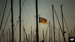 FILE - A Catalonia independence flag waves on a mast of a boat at the port of Vilanova i La Geltru, Spain, Oct. 31, 2017. 