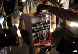 Members of Socialist Unity Center of India collect relief funds for Chennai flood victims at a traffic crossing in Hyderabad, India, Dec. 8, 2015.