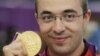 Romania's Alin George Moldoveanu poses with his gold medal during the 10m air rifle men's victory ceremony during the London 2012 Olympic Games July 30, 2012.